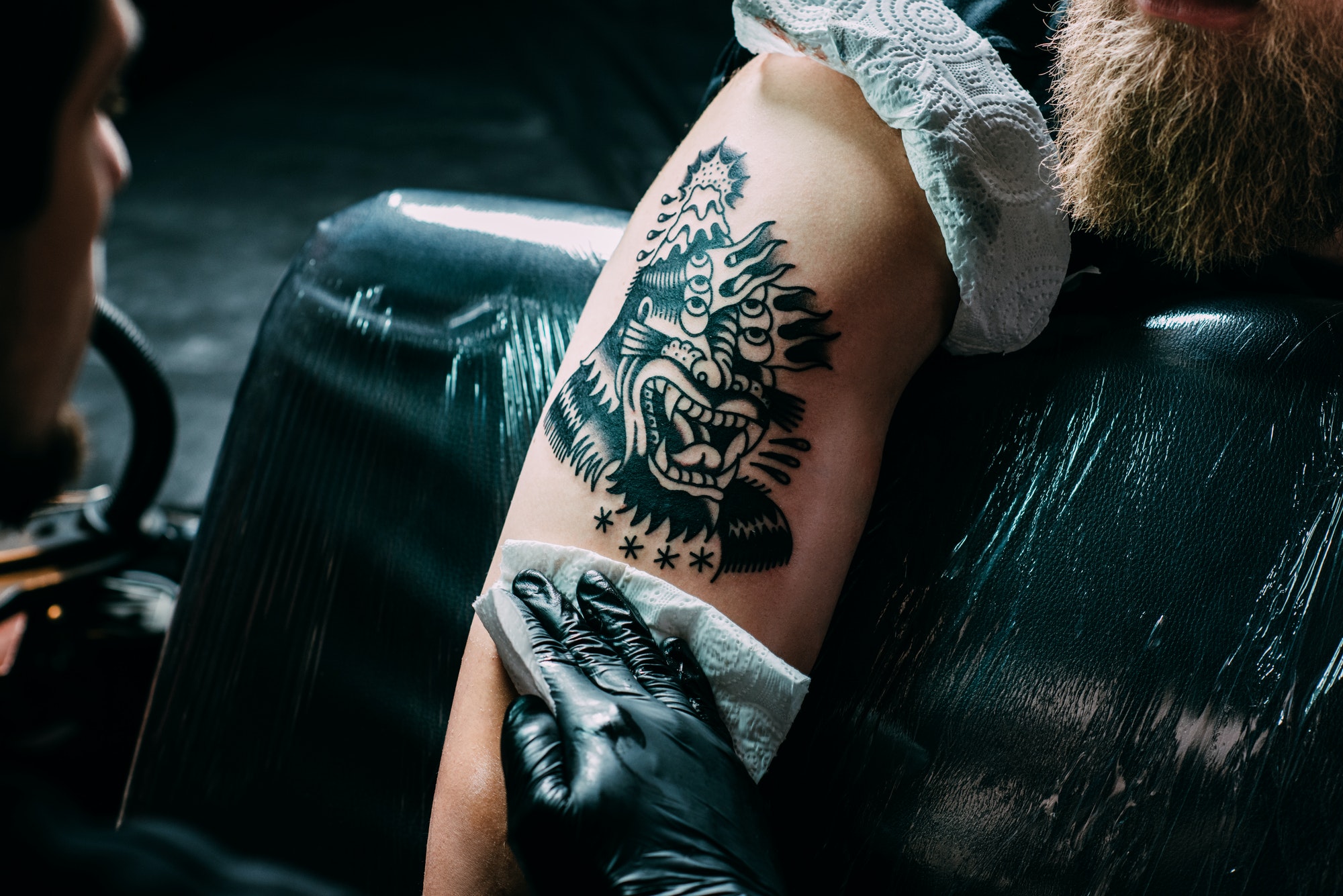 Traditional black beast tattoo freshly done on upper arm